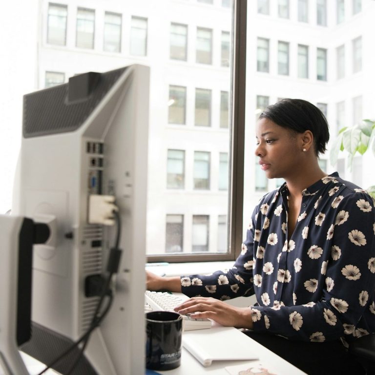 Executive function coaching for adults Woman working at laptop at desk